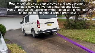 Van bogged on Pavement - steep hill, wet surface, no idea