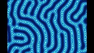 Oscillatory Turing Pattern Traveling Waves in Labyrinthine