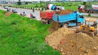 New perfect project! operator skills dozer d20p pushing soil process with dump trucks unload