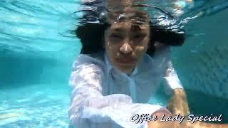 WETLOOK: Playing in the pool in her business suit