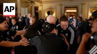 King Charles gets a group hug from the New Zealand women's rugby team