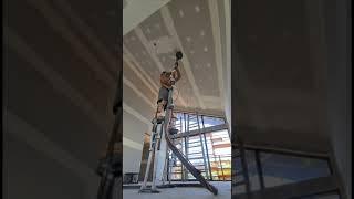 Sanding 5 Metre high raked ceiling of stilts