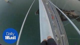 Terrifying moment teenage daredevil risks his life to climb Forth Road Bridge in Scotland