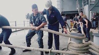 Sailors Pull Mooring Lines Aboard Aircraft Carrier USS George H.W. Bush