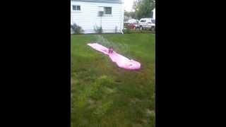 Lil girl playing on slip and slide:)