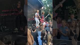 Can't believe this happened!  10 year old asks band at festival to let him play guitar..