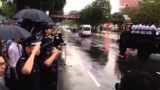 Home team officers saluting as the gun carriage drives past Cantonment Complex