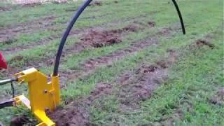 Implements Direct Single tine ripper with pipe laying attachment demo