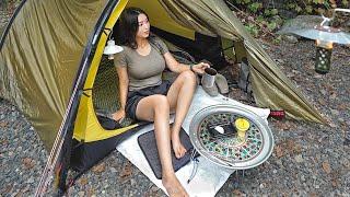 Girl solo camping in a small tent next to a chestnut tree. Hilleberg minimal tent.