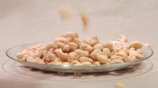 Cashews Nuts Falling Down Into Glass Bowl (Stock Footage)