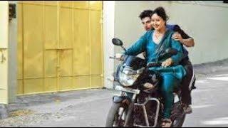 Mother riding bike with son in Indian dress