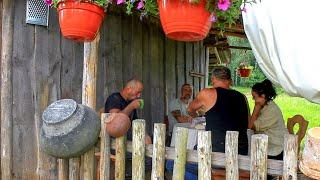 Family life in a forest village. Hard work rebuilding a house. Cooking outside