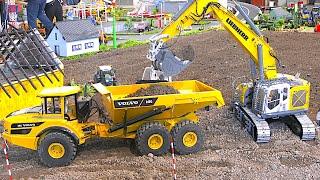 RC Trucks Digger Wheel Loader Dozer Dump Trucks Excavator working together at huge Construction Site