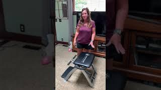 Folding up the Pilates Pro Chair for storage