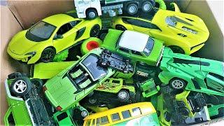 A box full of green car models