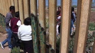 Mexican families reunite at the border wall that divides them