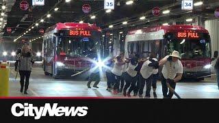 City of Calgary employees pull bus for charity