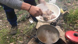 Lamb cooking with noodles in traditional Cretan way in olives land | Lamb