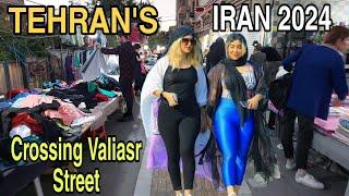 IRAN 2024 , Attractive women walking in Valiasr Street, passing by street vendors in Tehran