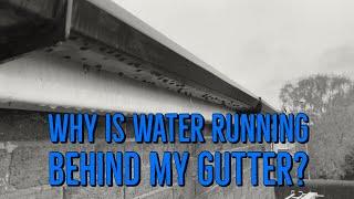 Why is water running behind my gutter?