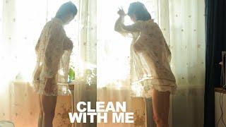 Transparent windowsill cleaning and care of houseplants with model girl in a dress