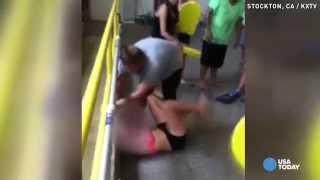 Video shows teacher dragging bikini-clad girl to pool