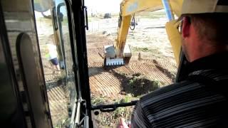 PC200 Stripping Top Soil Off a Pipeline