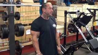 Lee Priest doing Leg Extensions on Ironmaster Super Bench