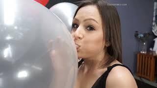 Sexy looner girl blow to pop a clear balloon