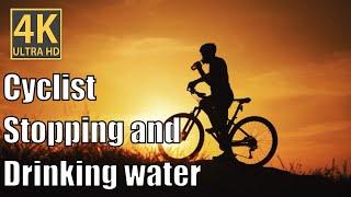 "Cyclist's Refreshing Pause: Stay Hydrated on Your Ride "