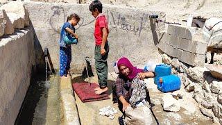 The nomadic life of Ferishte, Ali Akbar and Fariba, watering the flock in the head of the spring