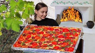 Woman сooking a giant village Pizza in a wood-burning oven, so easy and delicious