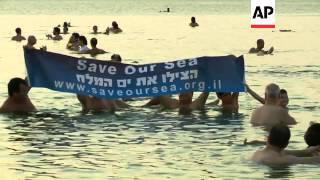 American photographer Spencer Tunick organises a 'mass float' shoot at dawn