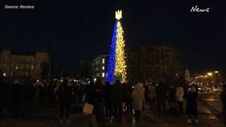 Christmas tree sparkles in dark Kyiv