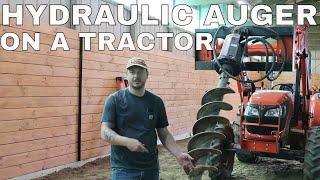 #67 HYDRAULIC AUGER ON A TRACTOR.