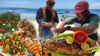 The residents of one village were made full | a variety of seafood is served at this table.