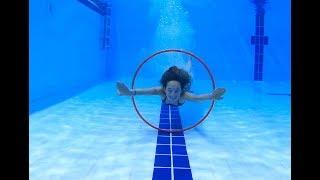 Carla Underwater playing with a Hula Hoop in a pool