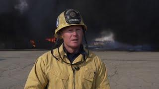 Two-alarm fire burning two warehouses in East Bakersfield