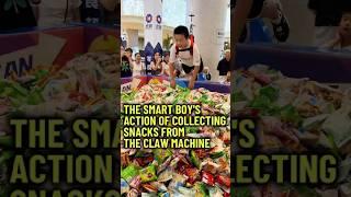 The Smart Boys’s Action Of Collecting Snacks From The Claw Machine