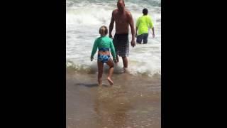 Little girl having problems with a sandy butt so funny