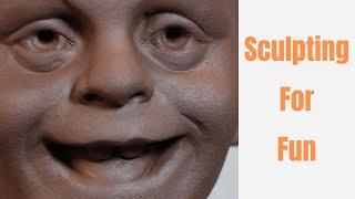 Sculpting silly face in clay . Sculpting for fun. Process of sculpting and playing with clay.