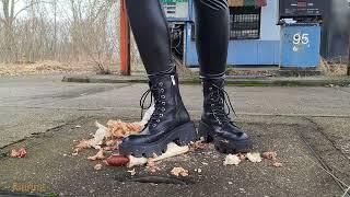 Workes boots crush hot-dogs on crushed by time, old petrol startion