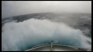 Massive waves, sailing a cargo ship through stormy seas in the Antarctic ocean