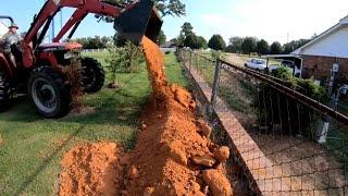 Mahindra tractor building a berm. #34