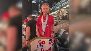 Lilly King gifts her gold medal to young swimmer