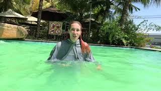 Beautiful pool with green water in a gray sports suit Kris