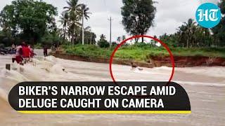 Karnataka rains: Biker swept away on flooded street, watch what happened next