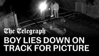 Shocking footage shows teens lying on high-speed railway track to pose for picture