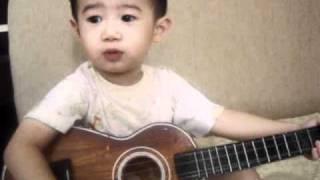 Playing Guitar n Sing a song by Nathan Christian Santoso 2 years old