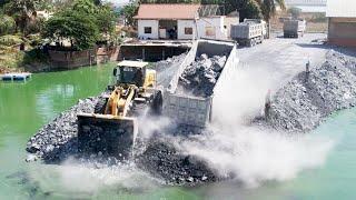 Processing Roads Foundation across the lake with Wheels loader SDLG & A lot of Heavy dump trucks